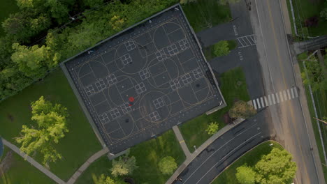 Aerial-over-blacktop-at-middle-school-with-slow-descent-all-the-way-down-to-four-square-graphic