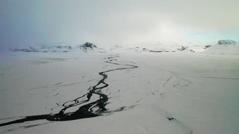 Rivers-flowing-through-the-ice-covered-landscape-of-South-Iceland---aerial