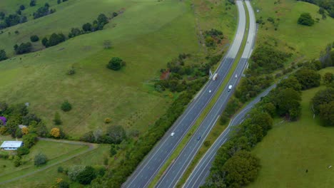 M1-Pacific-Motorway---Vehicles-Driving-On-Carriageway-Passing-By-Lush-Green-Fields-In-Byron-Bay,-Queensland,-Australia
