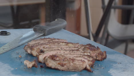 Pepper-being-sprinkled-on-cooked-and-cut-rib-eye-in-slow-motion