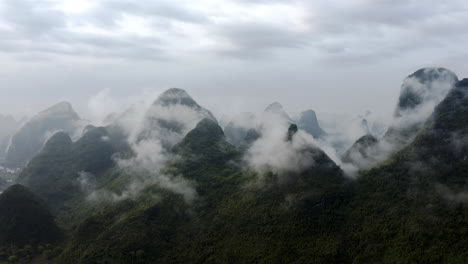 Cloudy-karst-mountain-Asian-landscape,-aerial-view