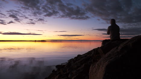 Silhouette-Of-Man-Taking-Phone-Photos-Of-Vivid-Ocean-Sunset