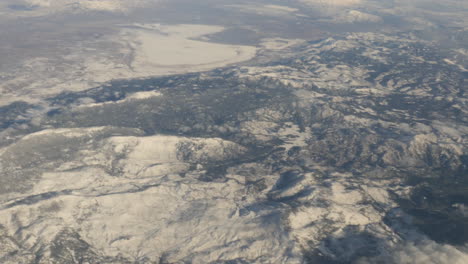 Aerial-view-of-Oregon-Snow-Capped-Mountains-with-clouds-out-of-plane-window-shot-in-4k-high-resolution