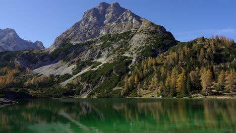 View-of-Sonnenspitze-mountain-in-autumn-with-the-tranquil-lake-Seebensee-in-the-foreground