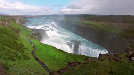 Panoramic-landscape-view-of-clear-blue-water-cascading-down-Gullfoss-golden-waterfall-in-canyon-of-Hvita-river,-Iceland