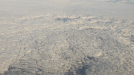 Aerial-view-of-clouds-out-of-plane-window-shot-in-4k-high-resolution