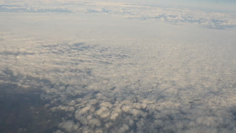 Aerial-view-of-clouds-out-of-plane-window-shot-in-4k-high-resolution