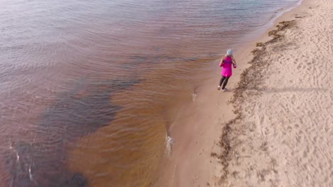 Jogging-in-winter-at-Carnikava-beach-Baltic-sea-aerial