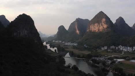 Li-River-flowing-through-Yangshuo-in-karst-mountain-landscape,-China,-aerial-view
