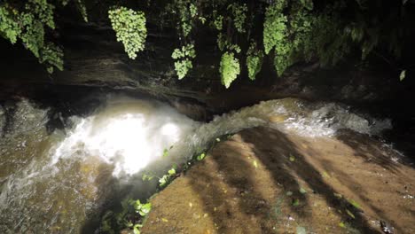 A-close-up-shot-of-running-waterfall-in-the-jungle-of-Tanzania-rainforest-rain-season-slowmotion