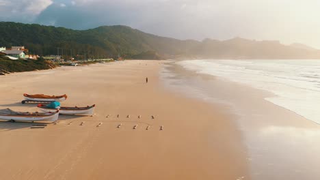 Drone-view-of-fisher-boats-on-beach-sand-in-the-morning-sunrise