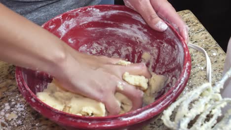 Anonymous-female-hands-mixing-and-preparing-homemade-dough-kneading-in-kitchen-bowl-closeup