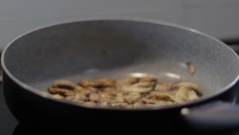 Adding-pepper-on-boiling-mushrooms-in-a-frying-pan