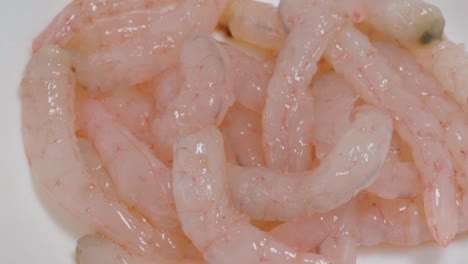 Rotating-Raw-Pink-Shrimp-on-White-Background,-Closeup-from-Above