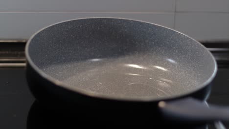 Pouring-cooking-oil-in-a-frying-pan