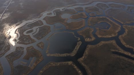 Backward-aerial-view-of-shaped-Engures-lake-islands-with-reflection