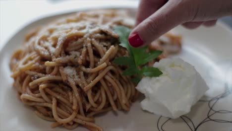 Decorating-a-pasta-portion-with-an-arugula-leaf