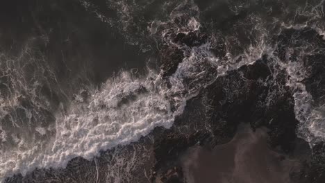 Aerial-view-birds-eye-perspective-overlooking-slow-motion-foaming-ocean-waves-scene