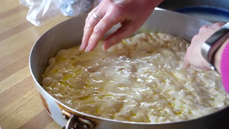 Spreading-Focaccia-Dough-Into-Metal-Pan---Homemade-Baking-60fps