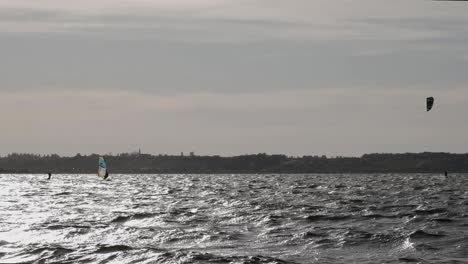 Scenic-View-Of-Kiteboarders-In-The-Baltic-Sea-In-Rewa,-Poland-Under-The-Dramatic-Sky---wide-slowmo-shot