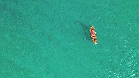 Aerial-top-down-view-fishing-boat-in-turquoise-water