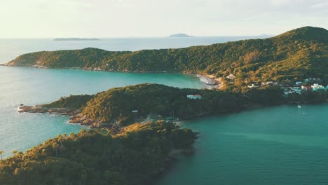 Amazing-paradise-rainforest-mountains-beach-coastline-with-turquoise-water-at-sunrise-arial-view