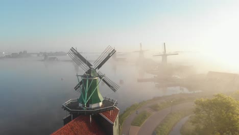 Drone-flies-over-the-windmills-at-the-Zaanse-Schans-on-a-foggy-morning-one