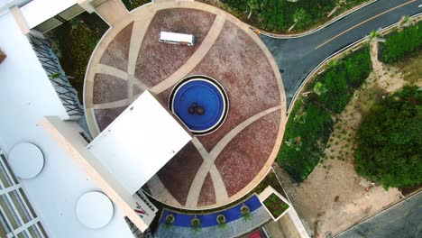 AERIAL-DIRECTLY-ABOVE-Resort-Hotel-Entrance-As-Tourist-Bus-Arives