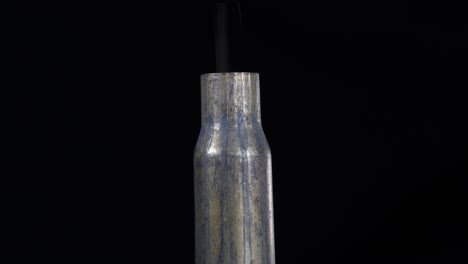 Close-up-macro-shot-of-a-bullet-casing-still-smoking-after-being-fired