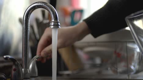 Filling-Glass-Of-Water-From-The-Stainless-Steel-Kitchen-Faucet
