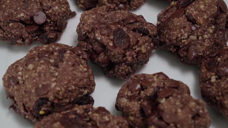 Tilt-Up-of-Oatmeal-raisin-cookies-on-white-background,-closeup-detail
