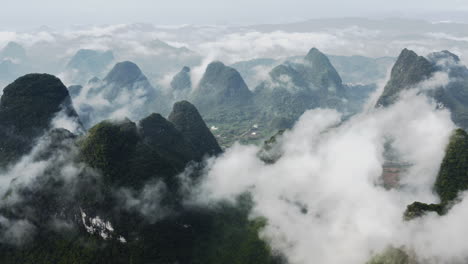 Dramatic-mountain-cloud-landscape,-Guangxi-karst-mountains-China,-aerial-footage
