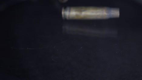 Close-up-of-empty-bullet-shells-falling-to-the-ground