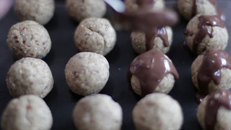 Pouring-melted-chocolate-on-sweat-balls