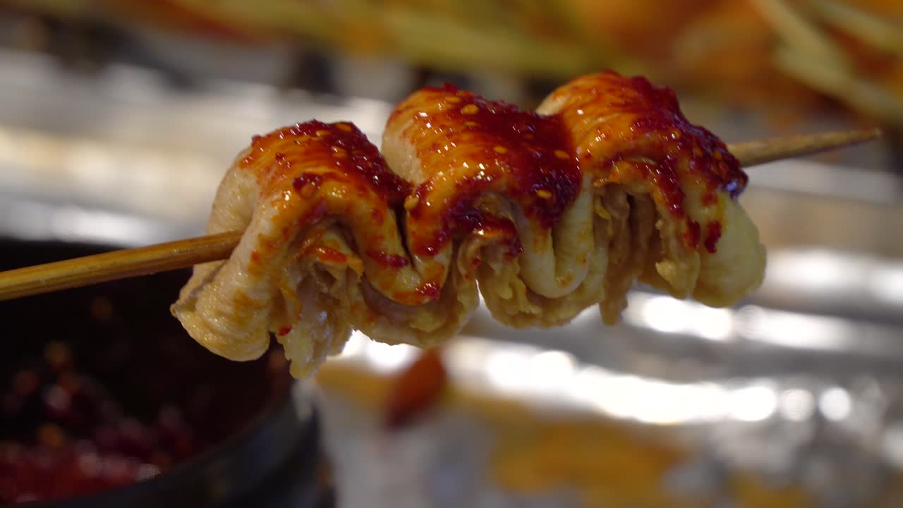 Premium stock video - One oden on wooden stick covered with spicy ...