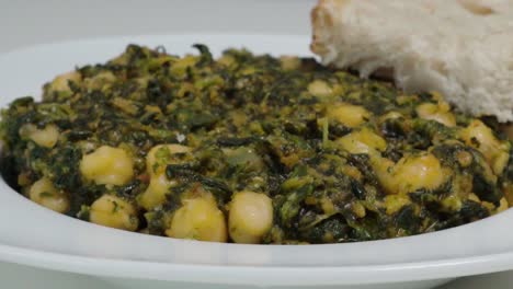 Typical-Spanish-dish-of-Garbanzos-with-Spinach,-Closeup-Pan-Left