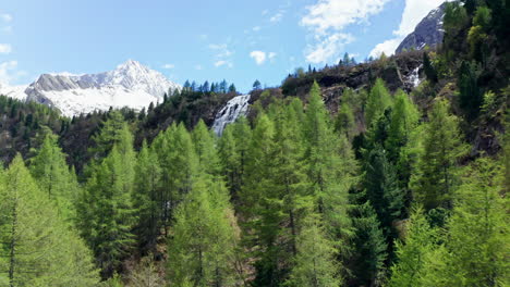 Flying-Low-Trough-Forest-Trees-Towards-Mountain-Waterfall