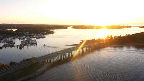 Aerial-View,-Cars-And-Boats-Travelling-In-The-Hamptons-At-Sunset