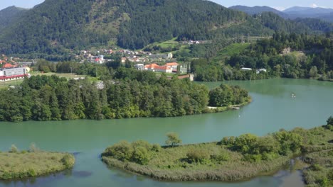 Mythical-islands-of-Dravograd-lake-Slovenia-aerial-tilt