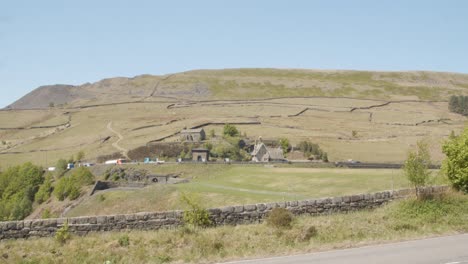 Timelapse-of-vehicles-driving-on-a-major-trans-Pennine-road-through-Woodhead-village,-Derbyshire