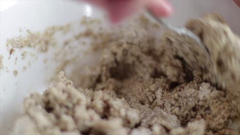 Mixing-Dough-Mixture-In-Bowl-With-A-Spoon---close-up-slowmo
