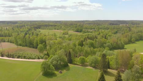 Serene-aerial-view-on-sunny-day-of-Kurzeme-nature-park,-flying-forward