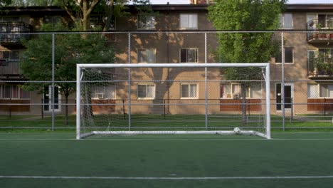 Static-shot-of-a-centered-soccer-goal-with-a-ball-hitting-the-net