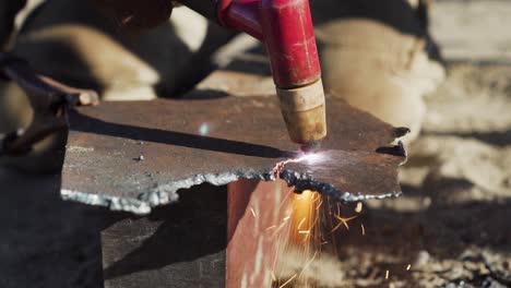 A-Craftsman-Cutting-A-Piece-Of-Steel-Plate-With-A-Cutting-Torch---close-up
