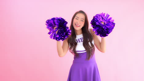 A-cheerleader-shakes-her-pom-poms-smiles-and-encourages-action,-Copy-space