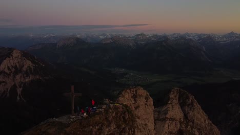 Drone-flying-above-a-summit-in-the-alps-at-sunset
