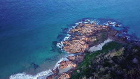 Beautiful-rocky-coastline-with-waves-breaking-on-shore,-Tasman-Sea,-aerial