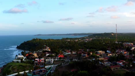 Beautiful-rising-aerial-drone-shot-of-the-tropical-coastline-of-Tibau-do-Sol-near-Pipa,-Brazil-on-a-warm-summer-evening