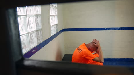 A-depressed-prisoner-is-sitting-in-his-cell