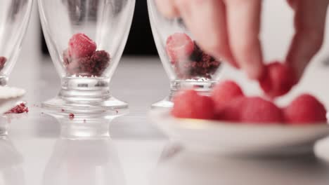 Cooking-delicious-tasty-raspberry-chocolate-dessert-grabbing-with-fingers-from-a-plate-on-local-restaurant-detail-medium-shot